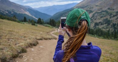 woman taking photo of mountain