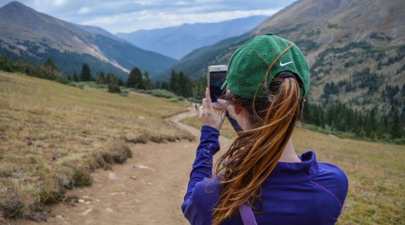 woman taking photo of mountain